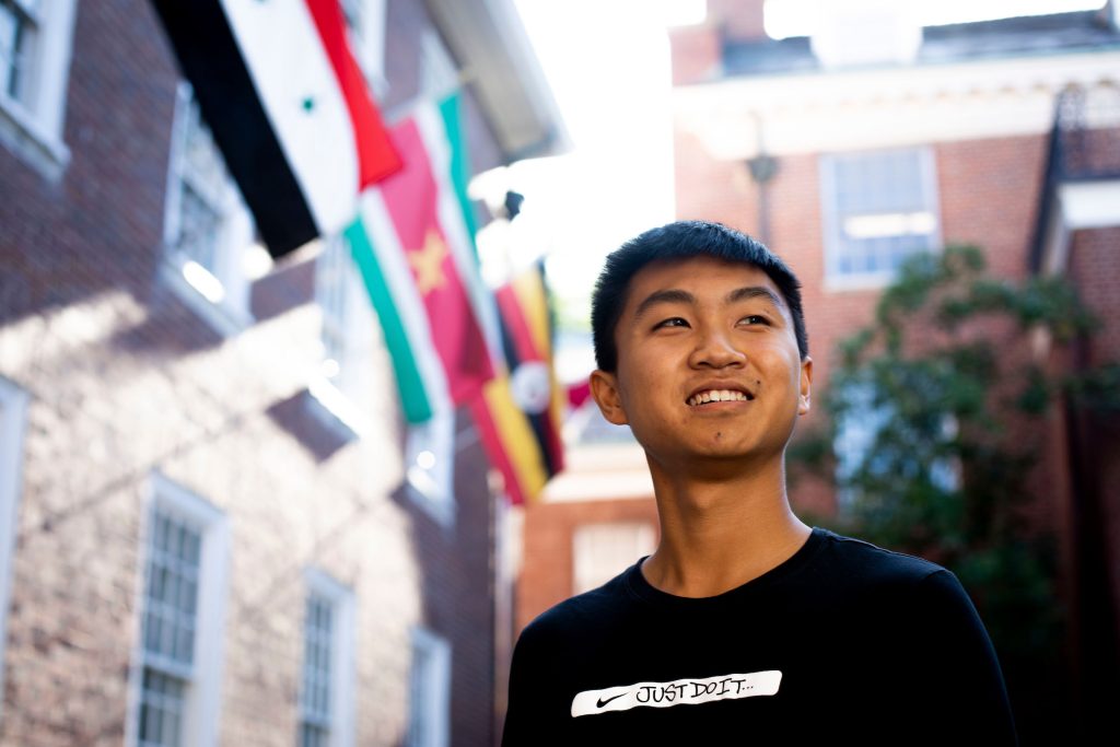 Student standing outside looking into the distance