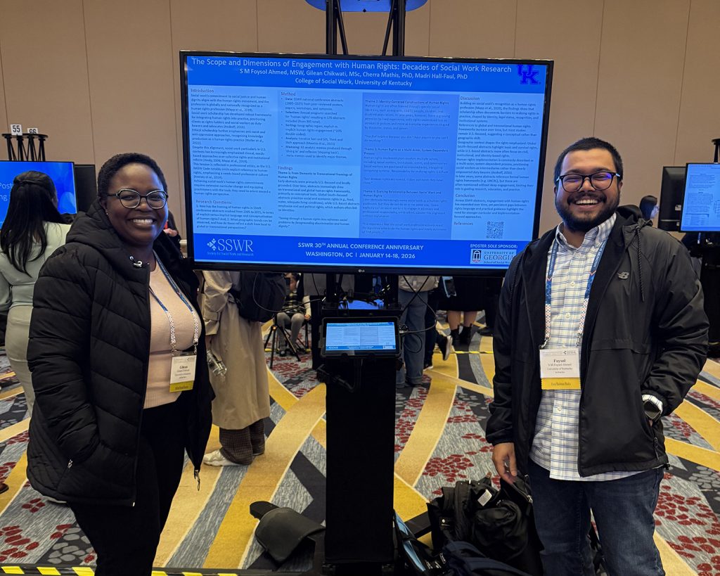 PhD students Gilean Chikwati and Foysol Ahmed in front of their poster presentation at the 2026 SSWR Conference