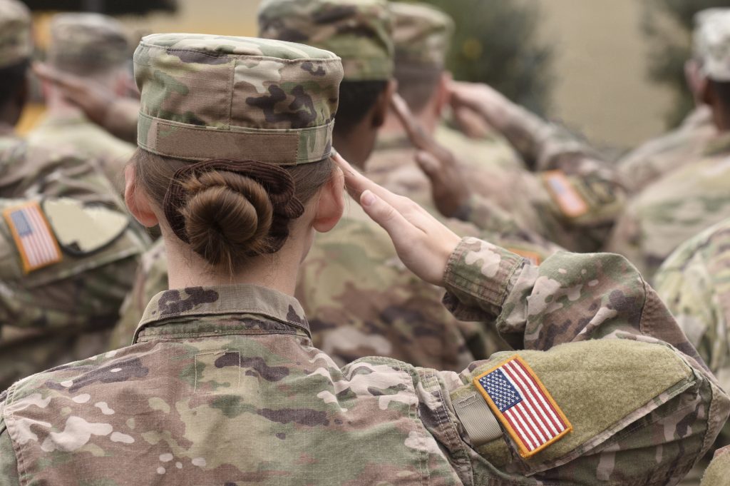 Woman in military uniform saluting