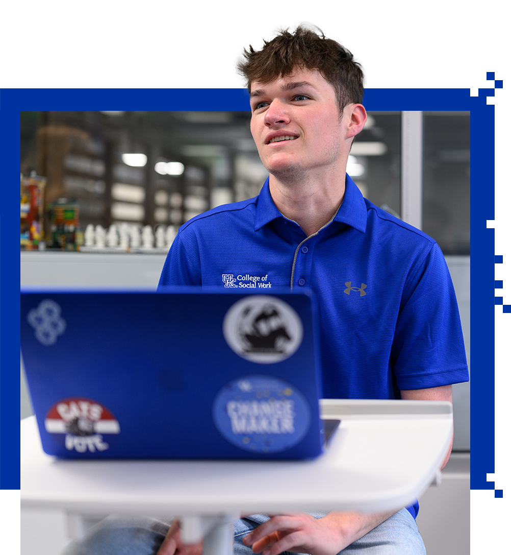 Student Ben Ison sitting in the moving meeting room with his computer